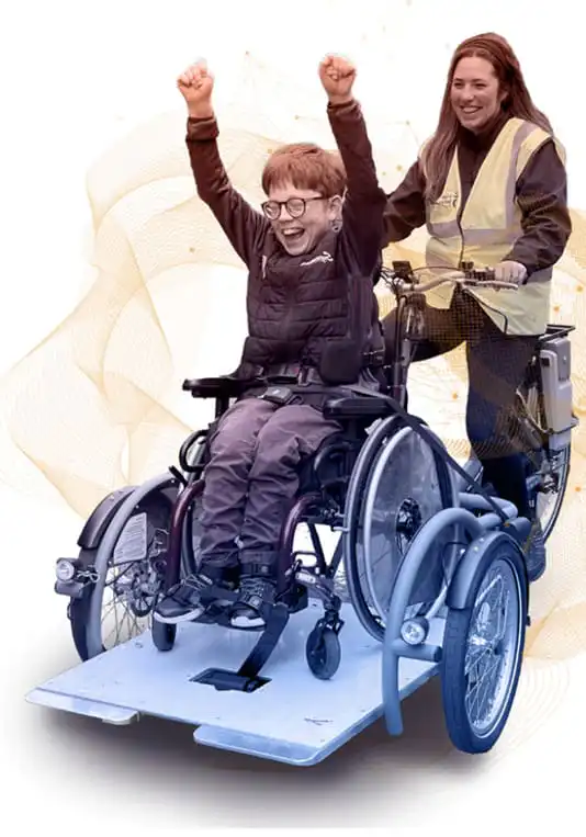 Child in wheelchair celebrates with caregiver assisting