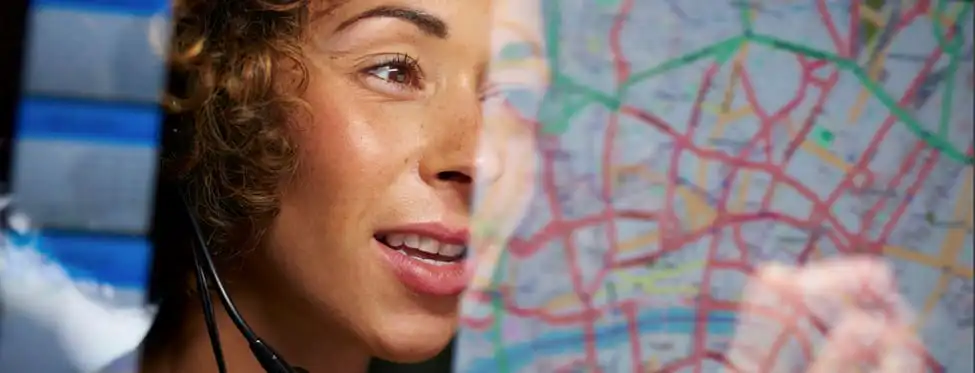 Woman with headset reviewing city map