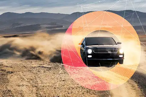 Black SUV speeding on desert road with tech overlay